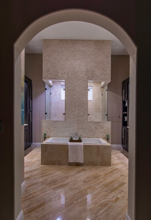 Photo of an expansive transitional master bathroom in Tampa with shaker cabinets, dark wood cabinets, a drop-in tub, a double shower, beige tile, stone tile, beige walls, porcelain floors, an undermount sink and engineered quartz benchtops.
