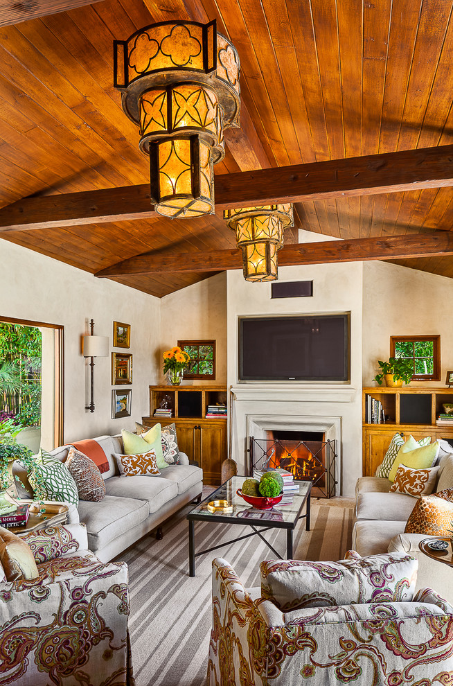This is an example of a mediterranean living room in Santa Barbara with a built-in media wall.