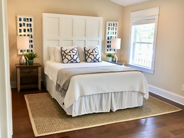 Inspiration for a mid-sized beach style master medium tone wood floor and brown floor bedroom remodel in Charlotte with yellow walls