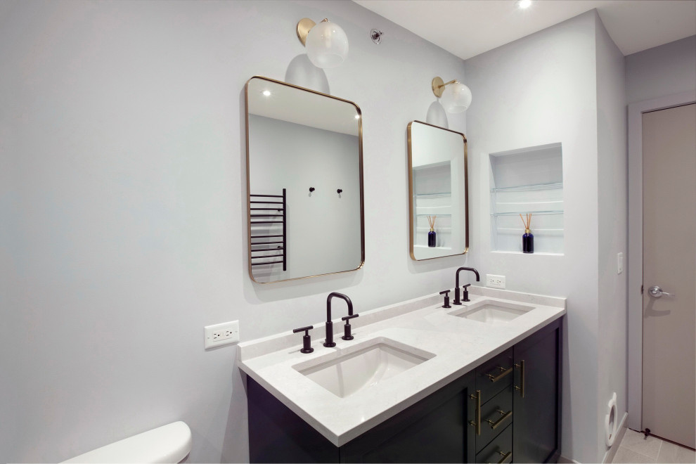 Mid-sized transitional master blue tile and porcelain tile concrete floor, beige floor and double-sink doorless shower photo in Chicago with raised-panel cabinets, blue cabinets, a two-piece toilet, blue walls, an undermount sink, quartzite countertops, a hinged shower door, white countertops and a built-in vanity