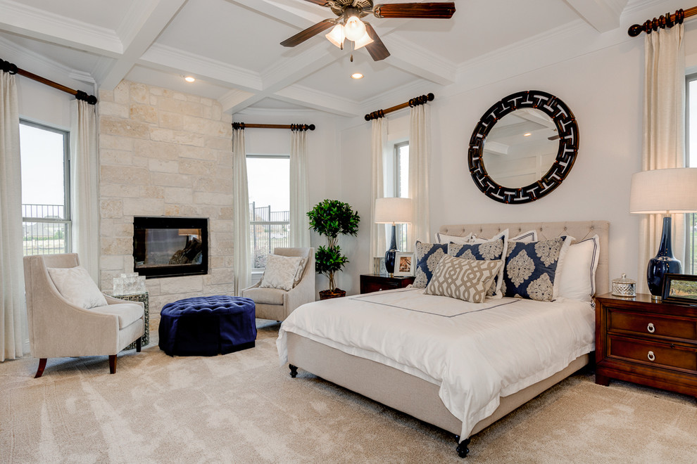 Inspiration for a traditional master bedroom in Dallas with white walls, carpet, a standard fireplace and a stone fireplace surround.