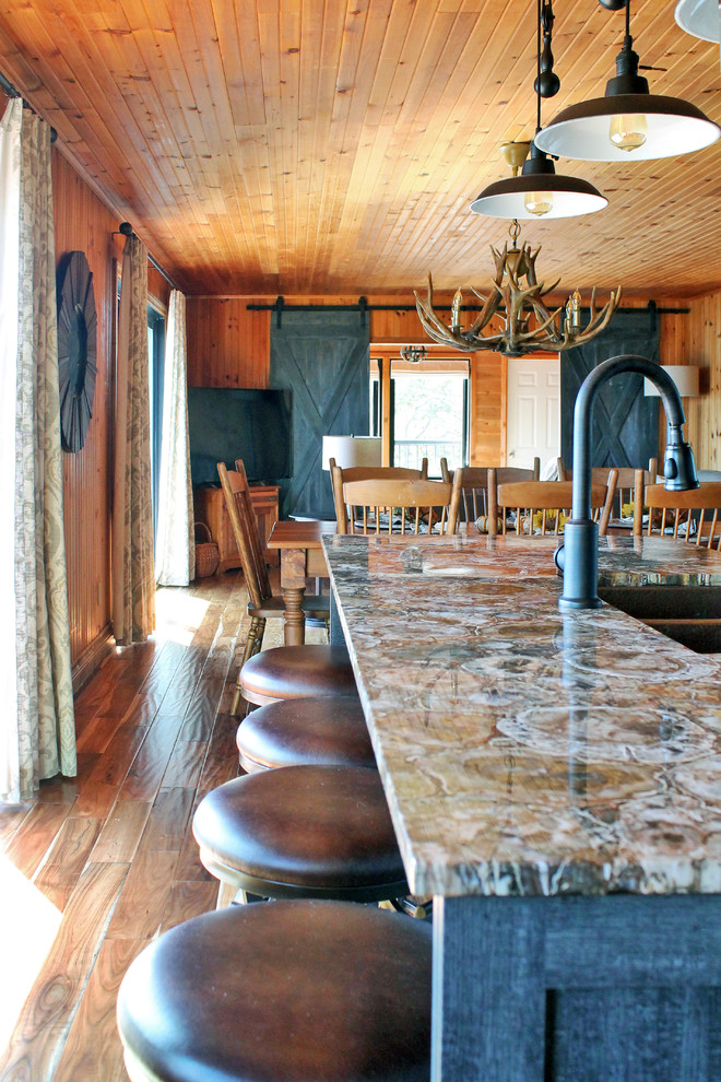 Eat-in kitchen - mid-sized rustic galley medium tone wood floor eat-in kitchen idea in Montreal with a farmhouse sink, shaker cabinets, distressed cabinets, quartz countertops, beige backsplash, ceramic backsplash, stainless steel appliances and an island