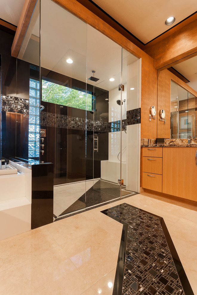 Inspiration for a mid-sized contemporary master bathroom in Phoenix with an undermount sink, flat-panel cabinets, light wood cabinets, granite benchtops, a drop-in tub, a double shower, a one-piece toilet, black tile, mosaic tile, multi-coloured walls and travertine floors.
