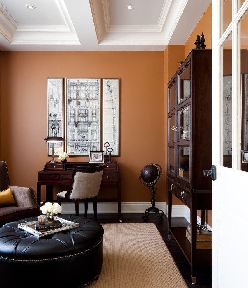Design ideas for a transitional home office in Toronto with orange walls.