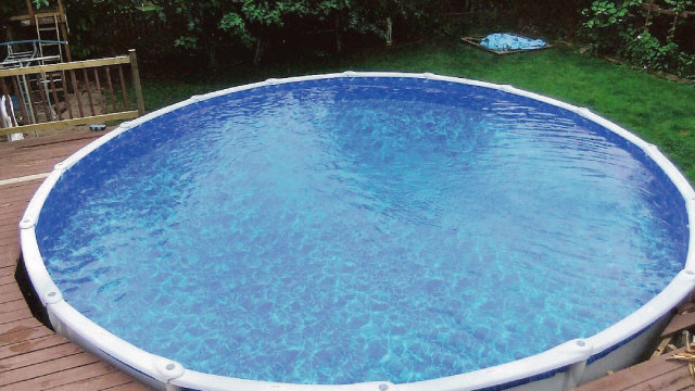 Pool - backyard gravel and round aboveground pool idea
