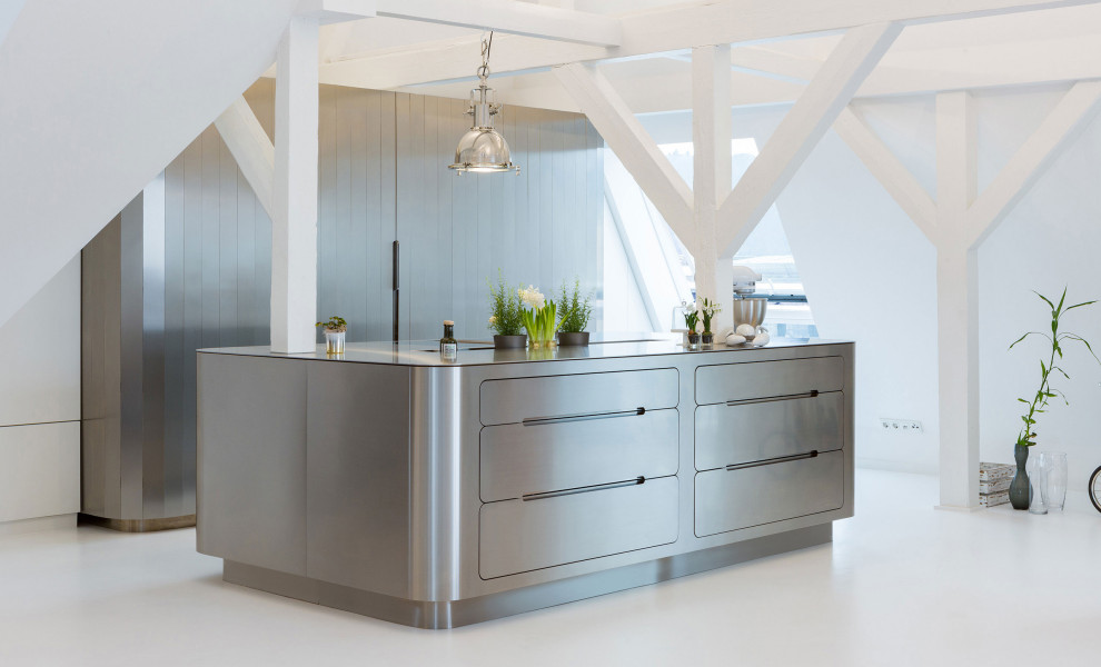 Design ideas for a large modern galley eat-in kitchen with a drop-in sink, flat-panel cabinets, stainless steel cabinets, stainless steel benchtops, stainless steel appliances, with island, concrete floors, white floor and exposed beam.