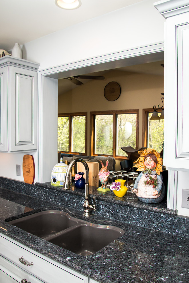 Example of a large transitional u-shaped porcelain tile and beige floor eat-in kitchen design in Milwaukee with an undermount sink, raised-panel cabinets, gray cabinets, granite countertops, white backsplash, marble backsplash, stainless steel appliances and no island