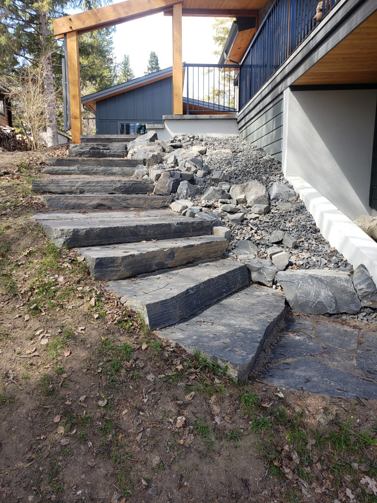 Inspiration for a mid-sized rustic partial sun backyard concrete paver landscaping in Edmonton for summer.