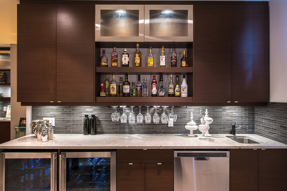Photo of a modern wet bar in Edmonton with flat-panel cabinets, brown cabinets, laminate benchtops, grey splashback, glass tile splashback and linoleum floors.