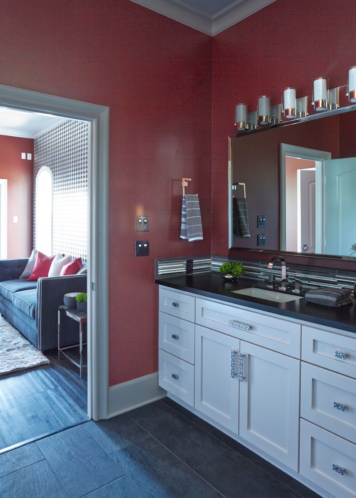 Design ideas for a mid-sized modern master bathroom in Other with recessed-panel cabinets, white cabinets, red walls, porcelain floors, a drop-in sink, granite benchtops, grey floor, black benchtops, a single vanity, a built-in vanity and wallpaper.