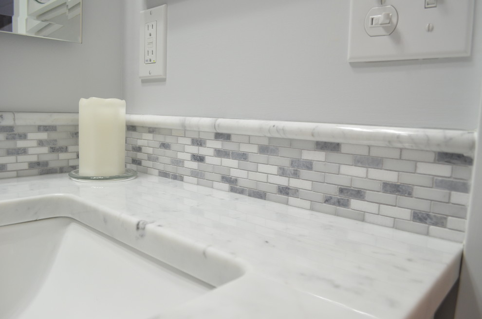 Bathroom - transitional gray tile bathroom idea with shaker cabinets, white cabinets and marble countertops