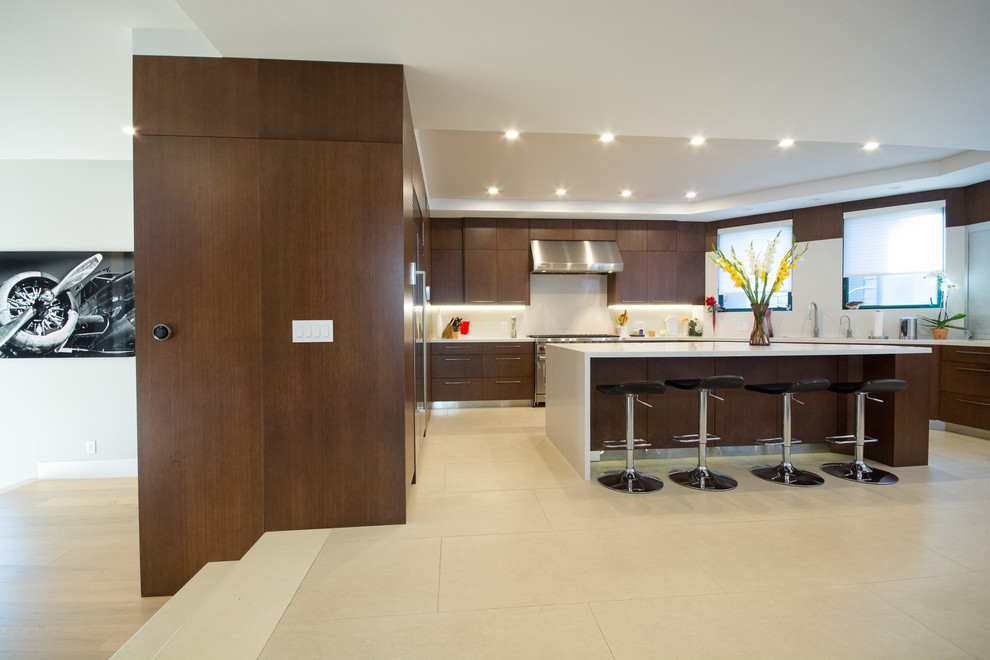 Mid-sized modern u-shaped eat-in kitchen in Los Angeles with a double-bowl sink, flat-panel cabinets, dark wood cabinets, soapstone benchtops, white splashback, stone tile splashback, stainless steel appliances, ceramic floors and with island.