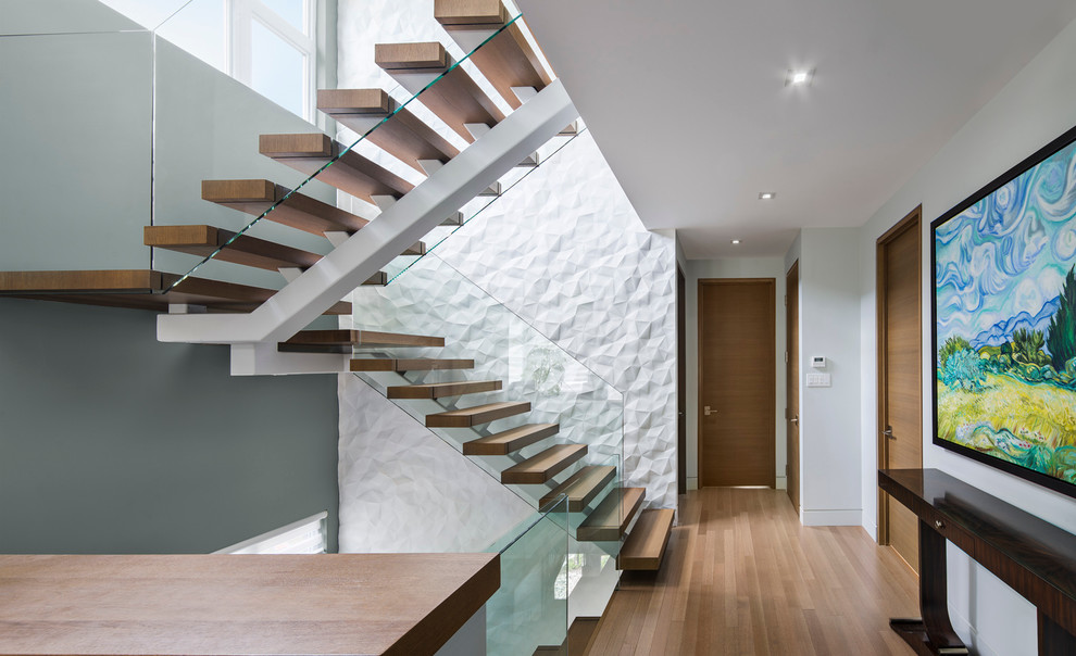 Photo of a contemporary hallway in Ottawa with white walls, light hardwood floors and brown floor.