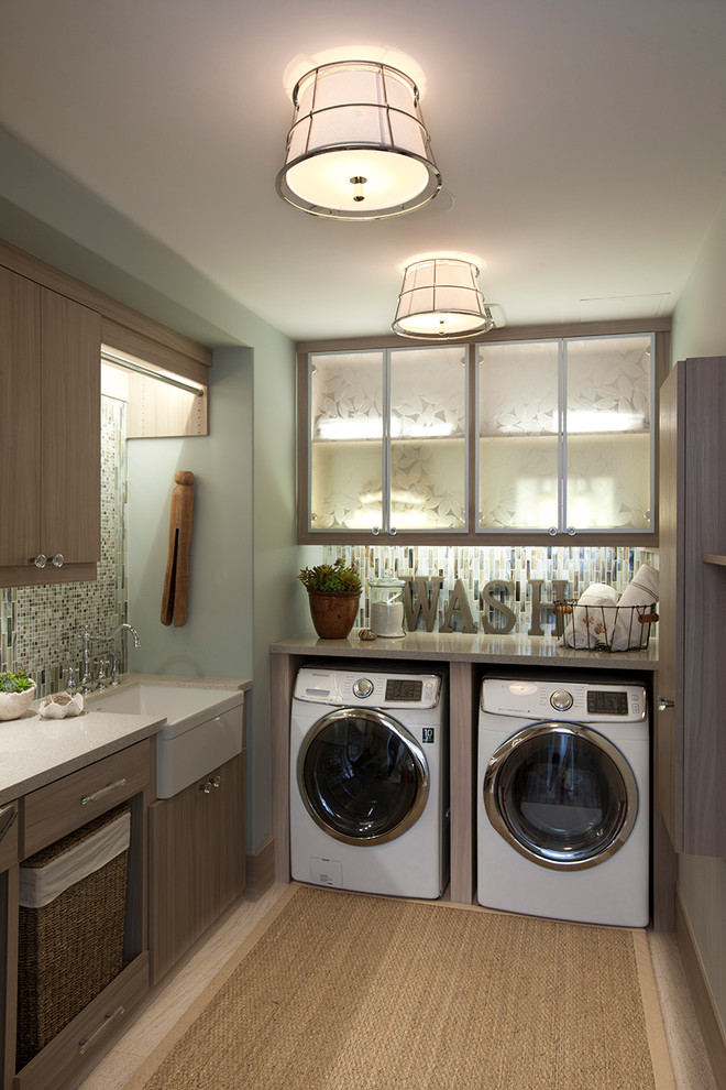 This is an example of a mid-sized eclectic l-shaped laundry room in Charlotte with a farmhouse sink, flat-panel cabinets, dark wood cabinets, green walls and a side-by-side washer and dryer.