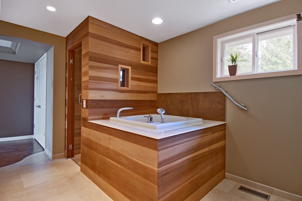 Design ideas for a contemporary bathroom in Seattle with a japanese tub, beige walls and beige floor.