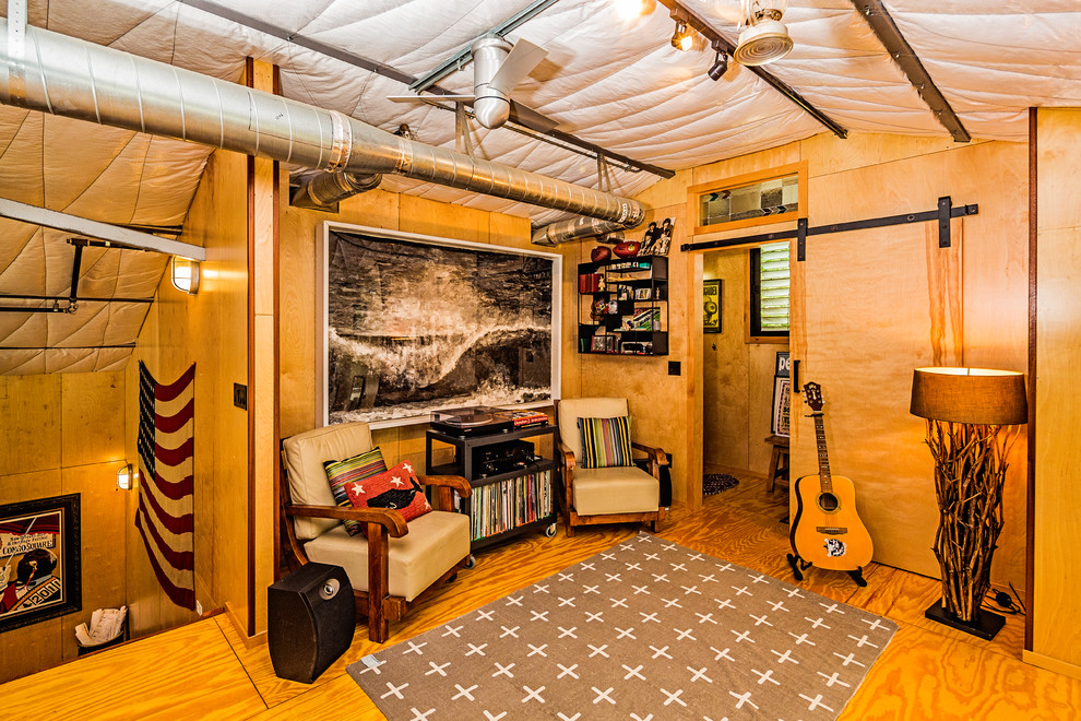 Photo of a small midcentury home studio in San Diego with plywood floors, yellow floor, no fireplace and brown walls.