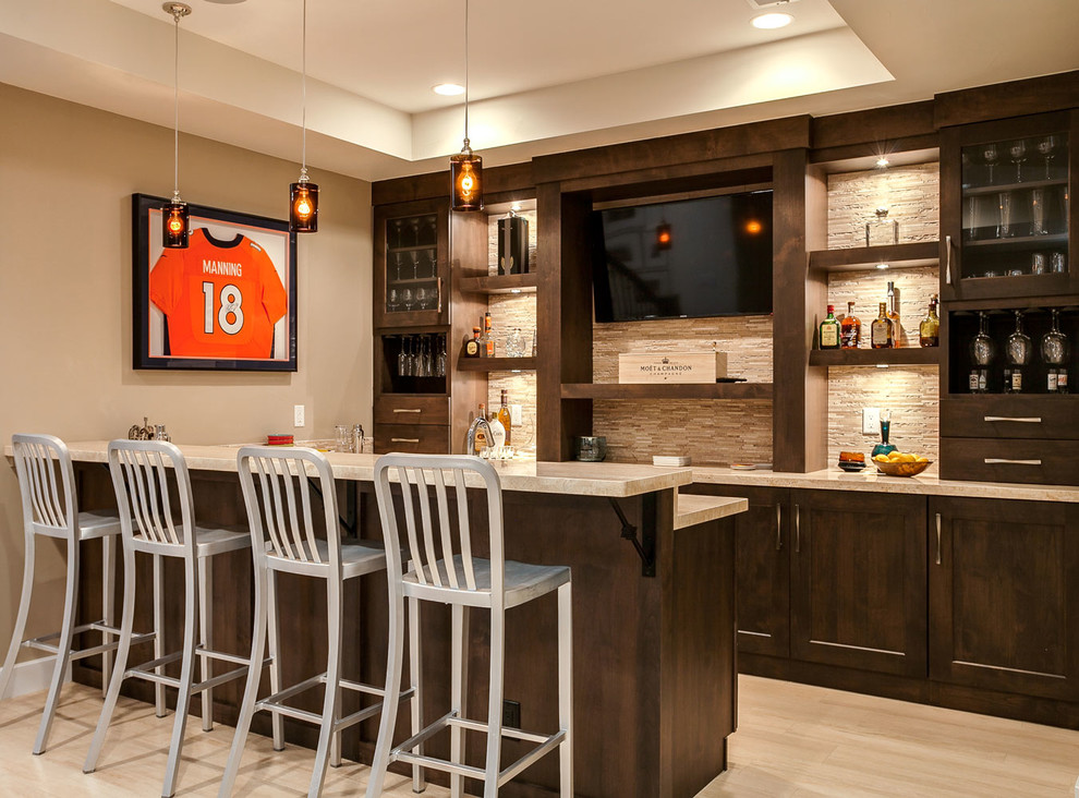 Design ideas for a mid-sized transitional galley wet bar in Denver with shaker cabinets, dark wood cabinets, beige splashback and light hardwood floors.