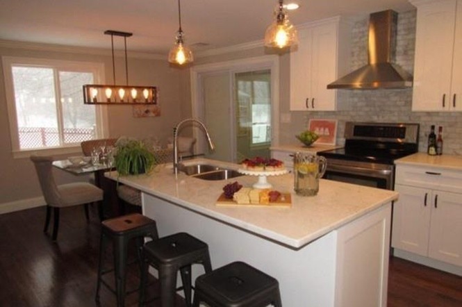 Example of a transitional l-shaped dark wood floor eat-in kitchen design in Boston with a double-bowl sink, shaker cabinets, white cabinets, marble countertops, gray backsplash, brick backsplash, stainless steel appliances and an island