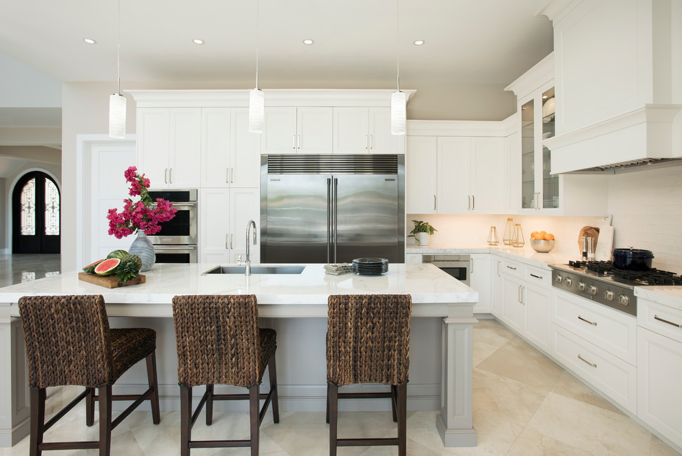 Open concept kitchen - mid-sized transitional l-shaped marble floor open concept kitchen idea in Miami with a single-bowl sink, shaker cabinets, white cabinets, marble countertops, white backsplash, ceramic backsplash, stainless steel appliances and an island