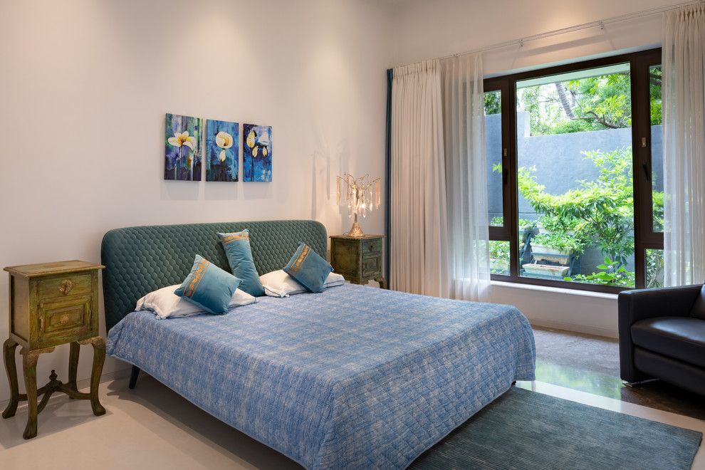 This is an example of a contemporary guest bedroom in Hyderabad with white walls and white floor.