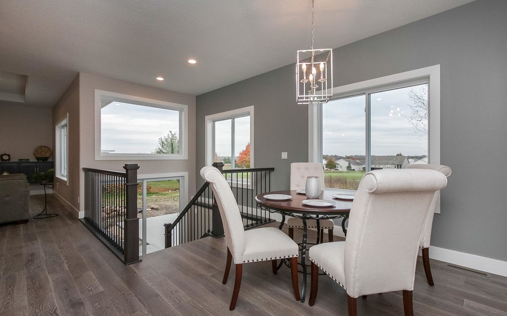 Mid-sized transitional dark wood floor and gray floor great room photo in Cedar Rapids with gray walls and no fireplace