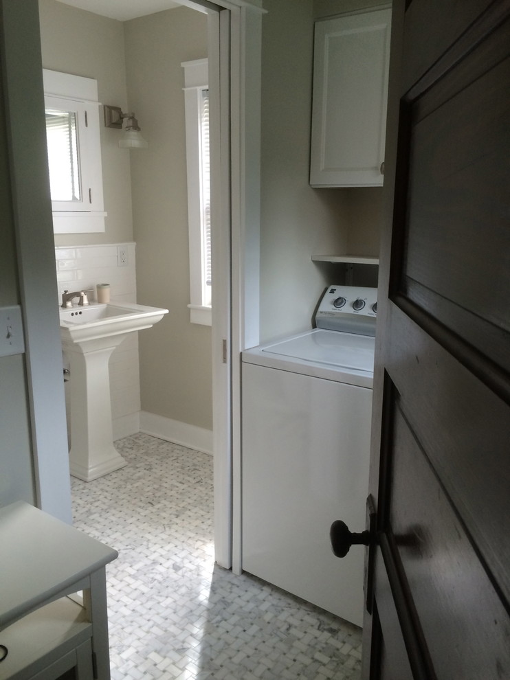Small arts and crafts single-wall dedicated laundry room in Milwaukee with recessed-panel cabinets, white cabinets, grey walls, ceramic floors and a side-by-side washer and dryer.