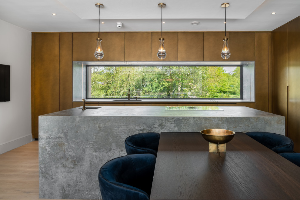 Modern galley kitchen/diner in Other with flat-panel cabinets, brown cabinets, granite worktops, an island, brown floors, grey worktops, a submerged sink, window splashback, integrated appliances and medium hardwood flooring.