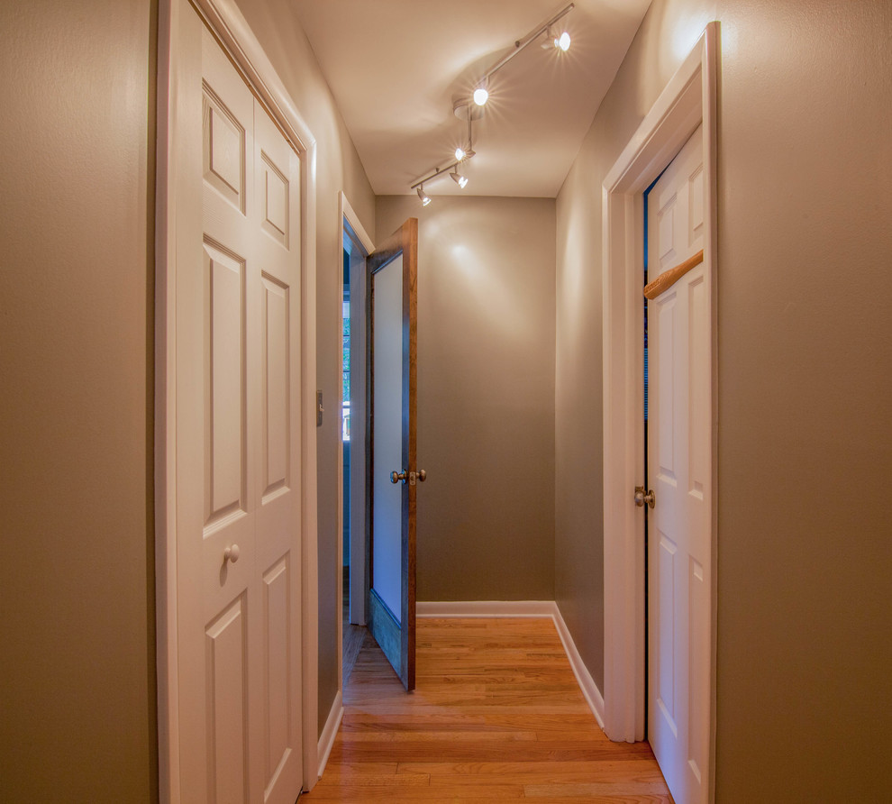 Hallway - mid-sized transitional light wood floor and brown floor hallway idea in Atlanta with gray walls
