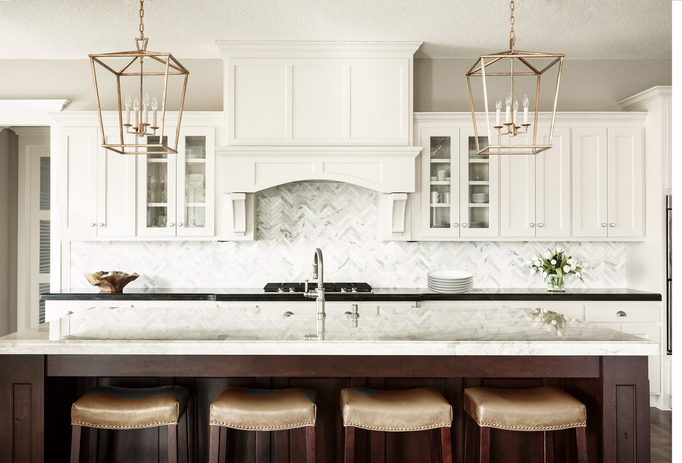 Inspiration for a large transitional l-shaped eat-in kitchen in Kansas City with a farmhouse sink, shaker cabinets, white cabinets, granite benchtops, grey splashback, ceramic splashback, stainless steel appliances, dark hardwood floors and with island.