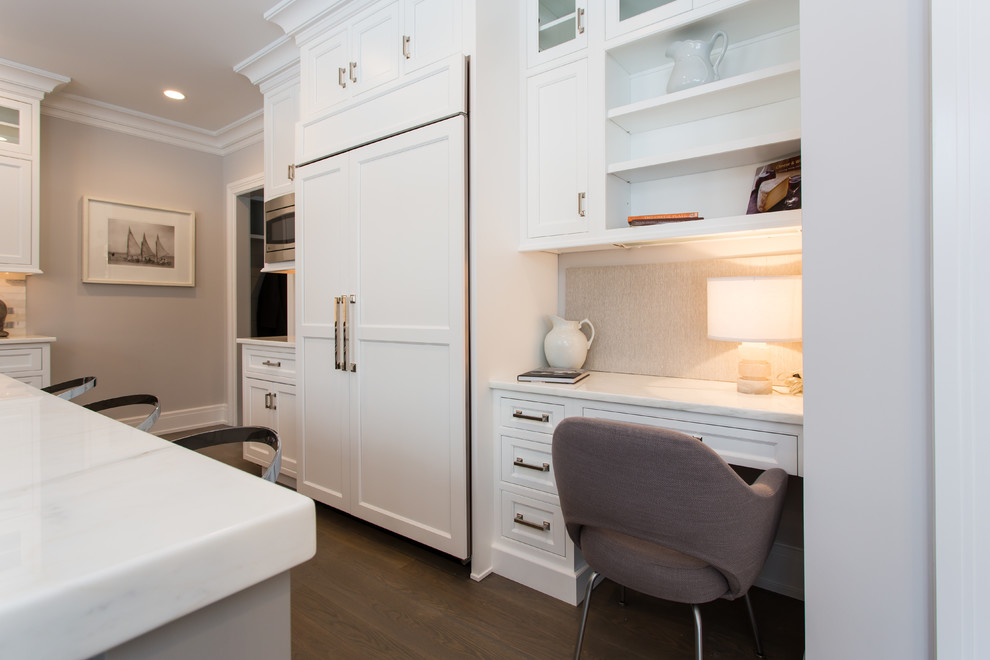 This is an example of a transitional u-shaped eat-in kitchen in Montreal with shaker cabinets, white cabinets, panelled appliances and medium hardwood floors.