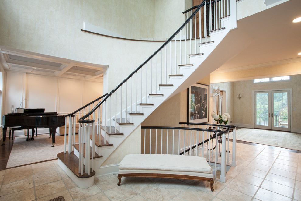 This is an example of a large traditional foyer in Philadelphia with beige walls, limestone floors and a double front door.