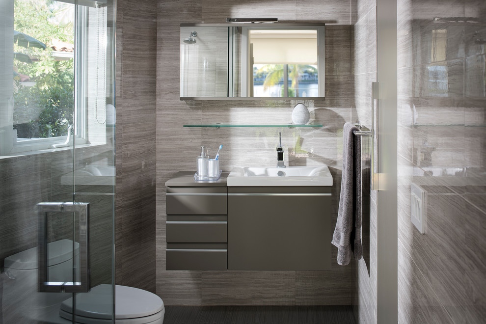 Photo of a small contemporary bathroom in Miami with flat-panel cabinets, beige cabinets, beige walls and a drop-in sink.