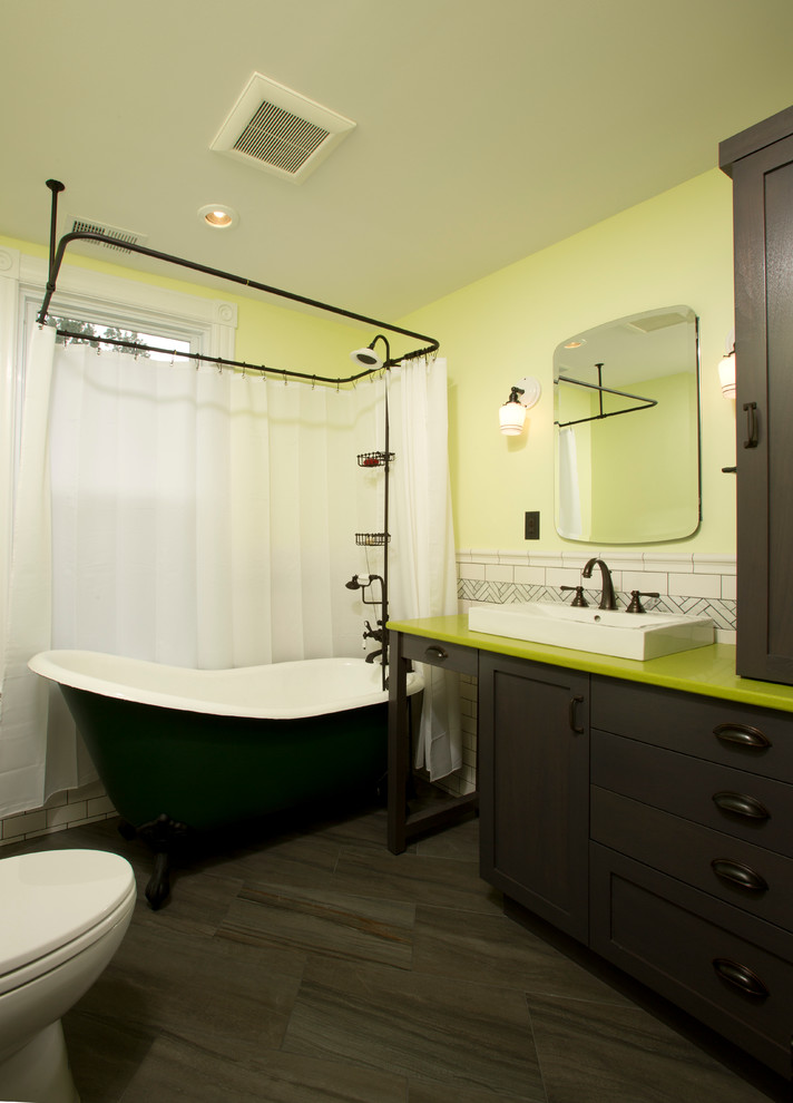 Design ideas for a small eclectic kids bathroom in DC Metro with a vessel sink, shaker cabinets, dark wood cabinets, engineered quartz benchtops, a claw-foot tub, a two-piece toilet, white tile, porcelain tile, yellow walls and porcelain floors.