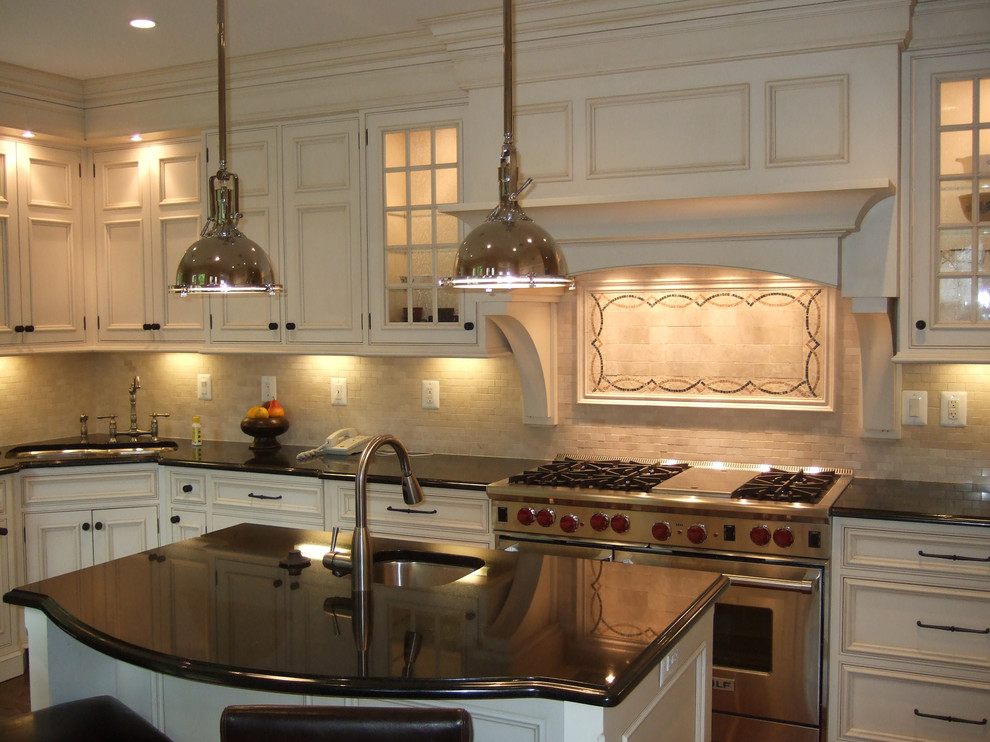Traditional kitchen in DC Metro with recessed-panel cabinets and stainless steel appliances.