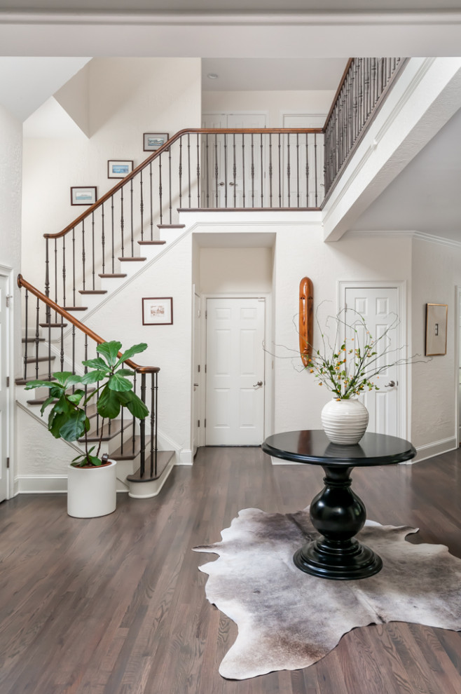 Photo of a large contemporary foyer in Atlanta with white walls, medium hardwood floors, a single front door, a black front door and grey floor.