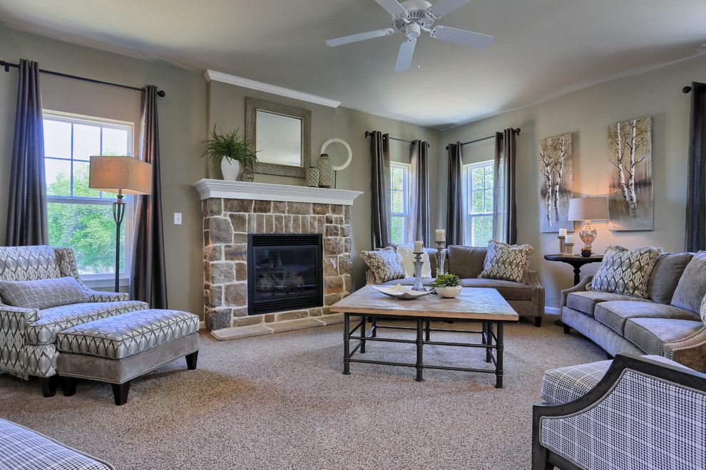 This is an example of a mid-sized traditional open concept family room in Other with beige walls, carpet, a standard fireplace, a stone fireplace surround and no tv.