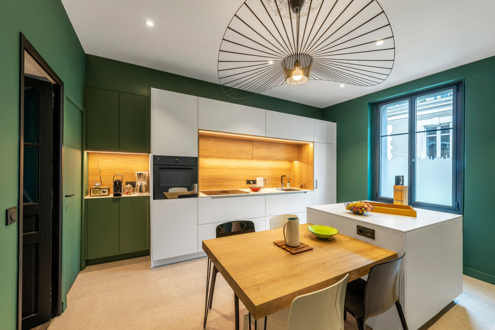 This is an example of a contemporary single-wall eat-in kitchen in Nantes with with island, flat-panel cabinets, white cabinets, brown splashback, black appliances, beige floor and white benchtop.