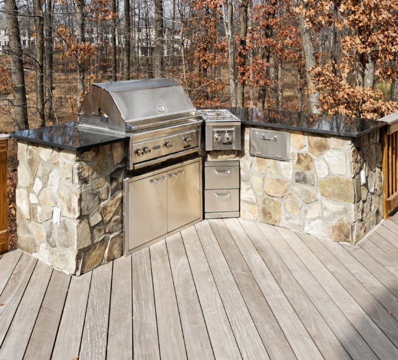 This is an example of a mid-sized traditional backyard deck in DC Metro with an outdoor kitchen.