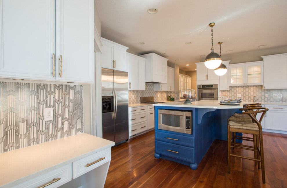 Mid-sized trendy l-shaped medium tone wood floor open concept kitchen photo in Other with an undermount sink, shaker cabinets, white cabinets, quartz countertops, multicolored backsplash, cement tile backsplash, stainless steel appliances and an island
