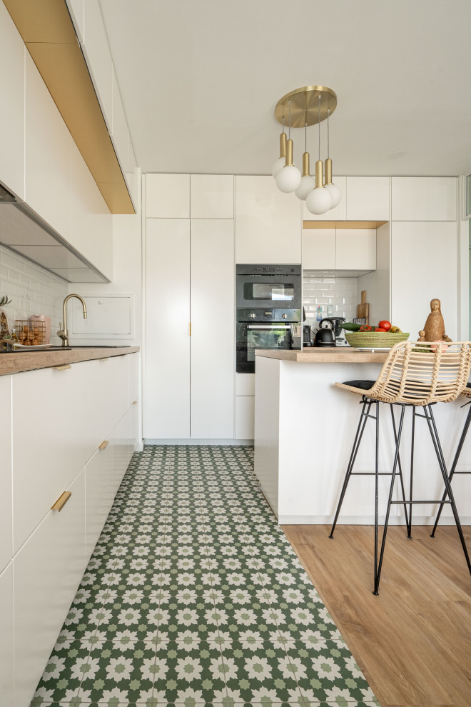 Inspiration for a large mediterranean l-shaped open plan kitchen in Paris with beaded inset cabinets, white cabinets, wood benchtops, medium hardwood floors and with island.