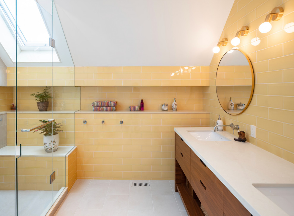 Photo of a large classic ensuite bathroom in Toronto with flat-panel cabinets, dark wood cabinets, an alcove shower, yellow tiles, ceramic tiles, yellow walls, ceramic flooring, a submerged sink, solid surface worktops, grey floors, a hinged door, white worktops, a shower bench, double sinks and a built in vanity unit.