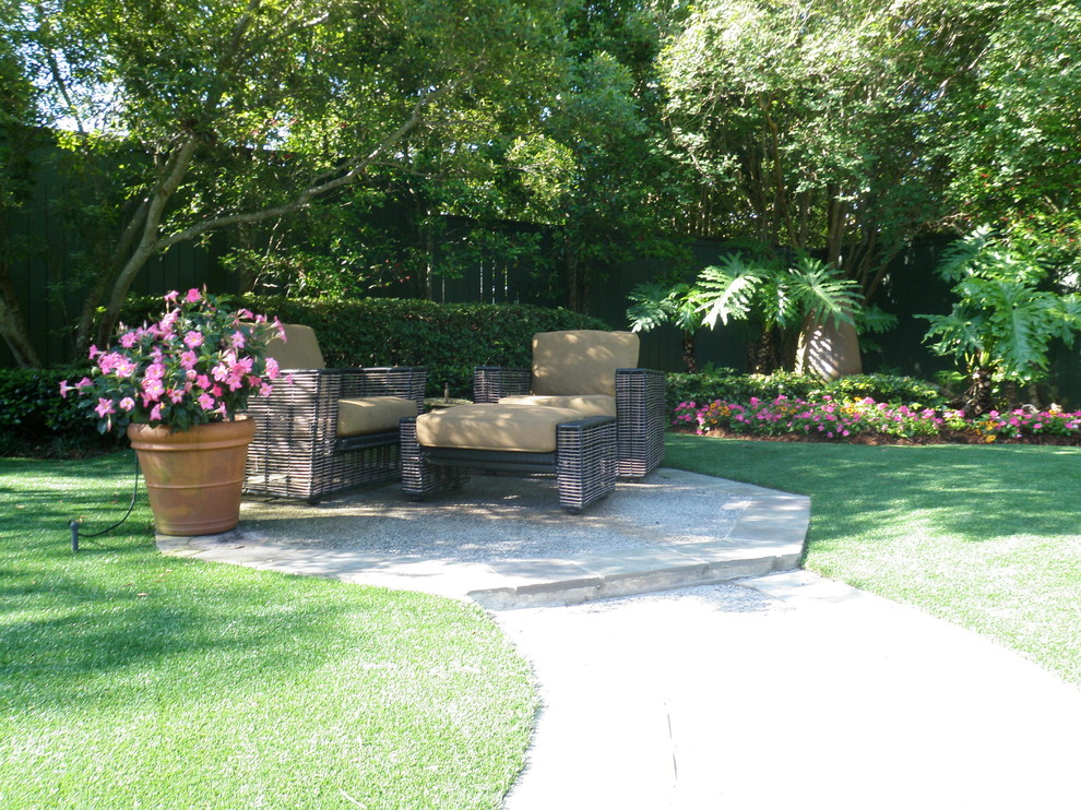 Inspiration for a mid-sized contemporary backyard full sun formal garden for summer in New Orleans with concrete pavers.