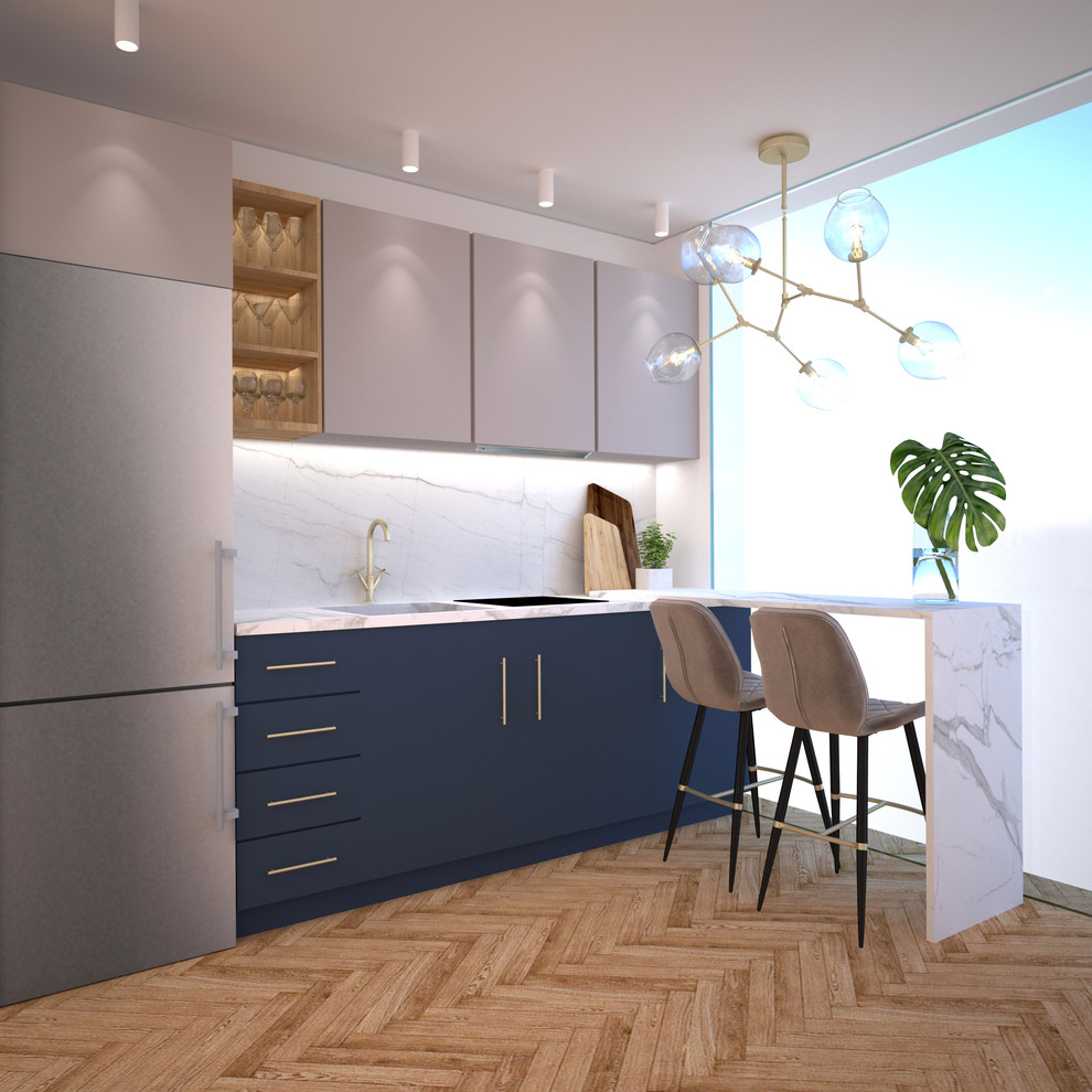 Design ideas for a small eclectic l-shaped open plan kitchen in Madrid with a single-bowl sink, flat-panel cabinets, blue cabinets, tile benchtops, white splashback, ceramic splashback, stainless steel appliances, medium hardwood floors, a peninsula, brown floor and white benchtop.