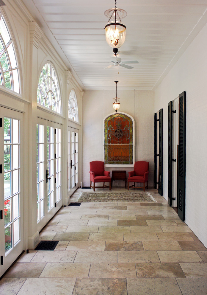 Photo of a large traditional hallway in Cincinnati with white walls and ceramic floors.