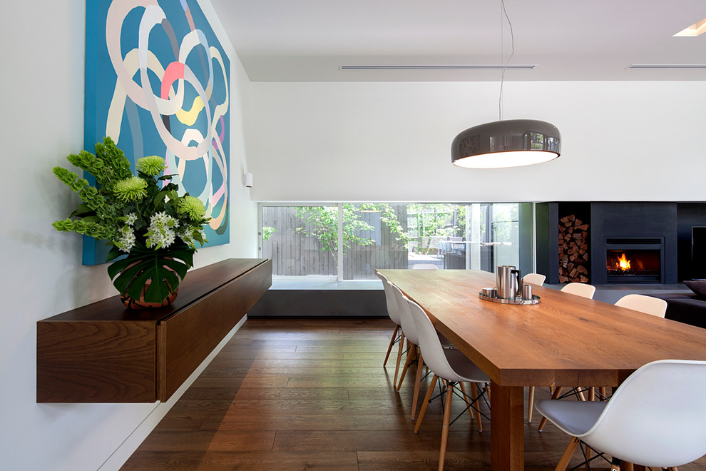 Contemporary kitchen/dining combo in Melbourne with white walls and dark hardwood floors.