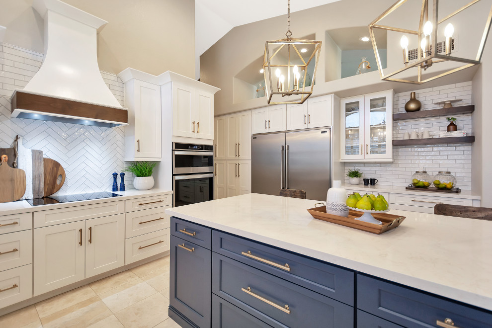 Inspiration for a large transitional u-shaped open concept kitchen remodel in Phoenix with a farmhouse sink, shaker cabinets, white cabinets, quartz countertops, white backsplash, subway tile backsplash, stainless steel appliances, an island and white countertops