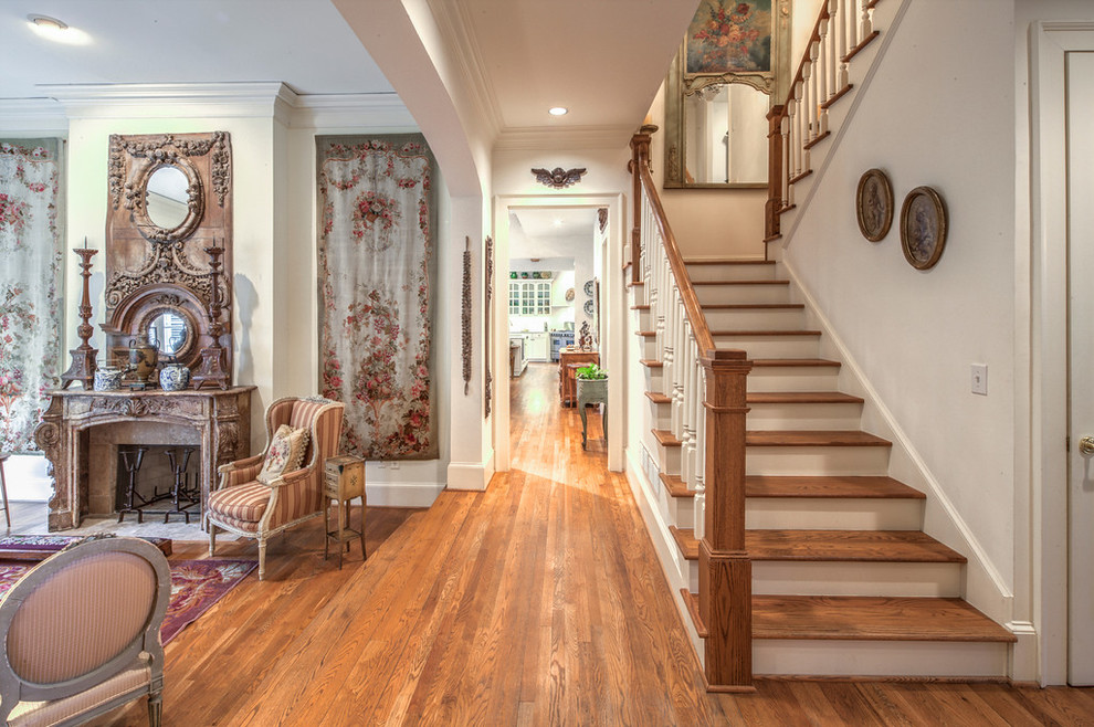 Photo of a large traditional wood u-shaped staircase in Atlanta with painted wood risers.