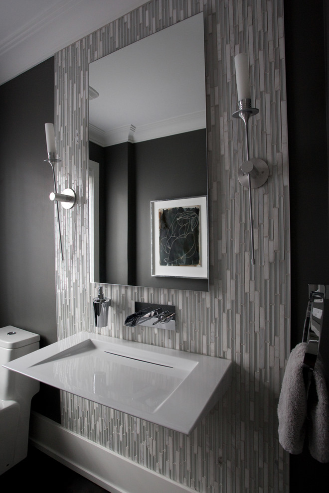 Photo of a large modern powder room in Toronto with a one-piece toilet, gray tile, grey walls, dark hardwood floors, a wall-mount sink and matchstick tile.