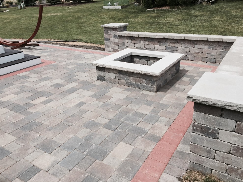 Photo of a mid-sized traditional backyard patio in Chicago with a fire feature and brick pavers.