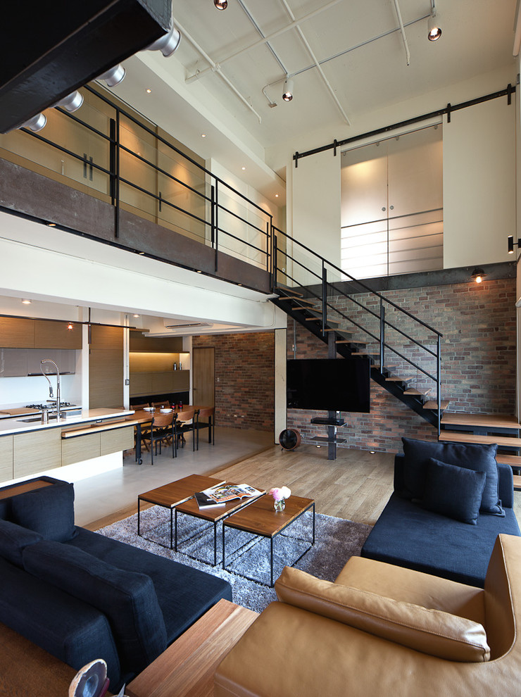 This is an example of an industrial open concept living room in Other.